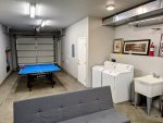 Private 2 car tandem heated garage with washer and dryer plus a foldable ping pong table